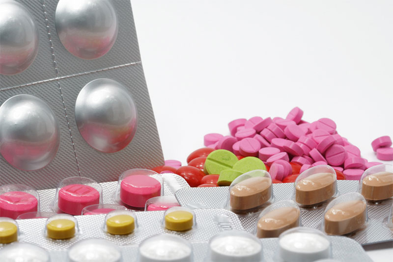 A photograph of various multicolored chewable tablets in blister packs