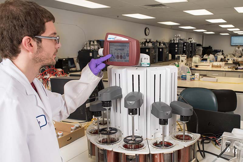 Lab technician conducting quality checks in Vitaquest lab. Lab technician conducting quality checks in Vitaquest lab.